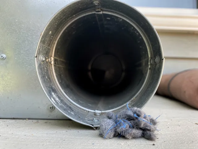 Pasadena Dryer Vent Cleaning technician using specialized equipment to clear severe dryer vent blockage in Pasadena